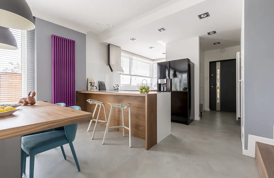 Kitchen open to the dining room with polished concrete floor