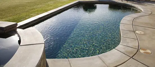 Gray colored imprinted concrete in swimming pool