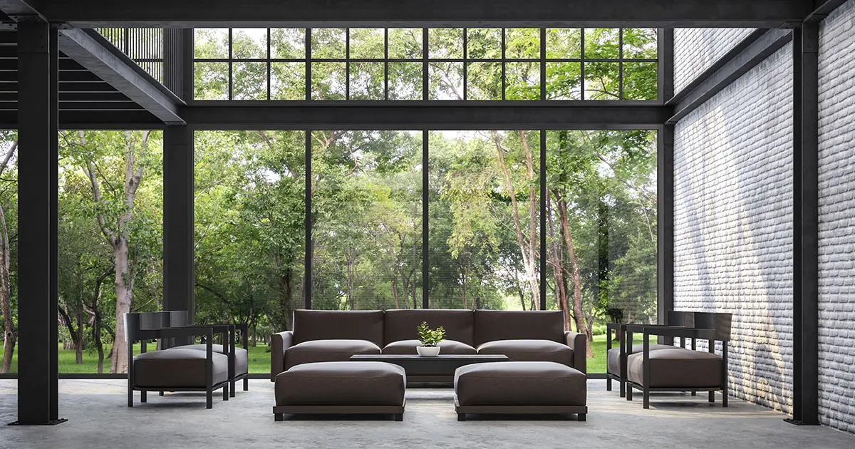 Microcement on the floor of an industrial-style living room overlooking a garden