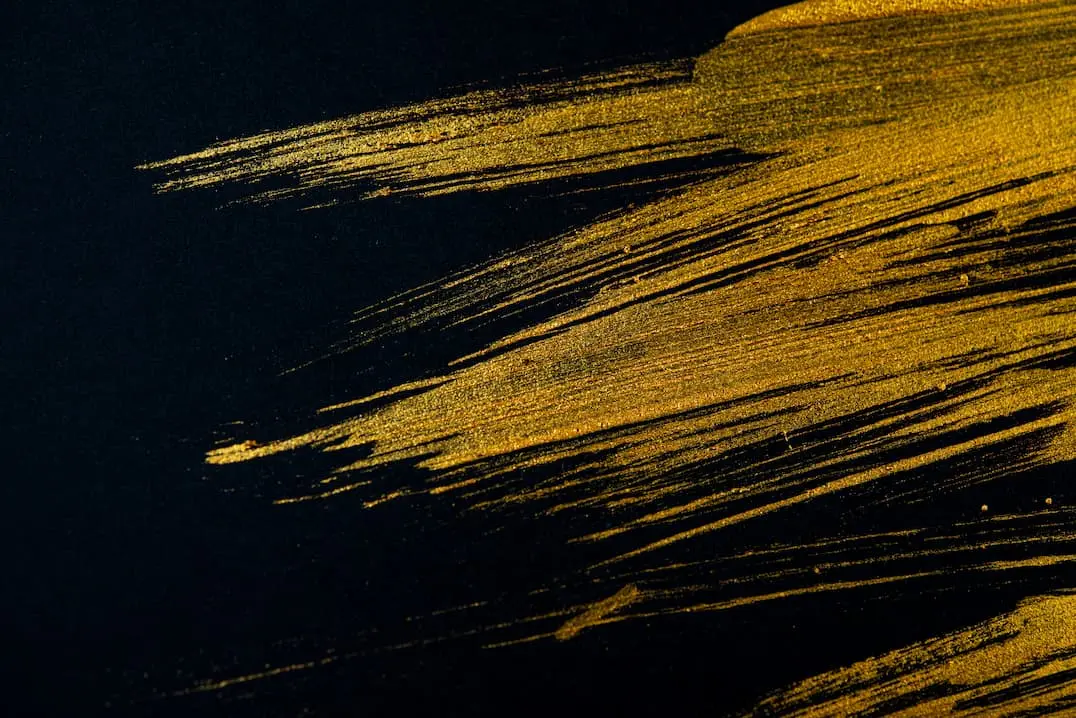 Sample of gold decorative paint on a black wall