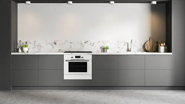 Gray microcement kitchen to which the two-component epoxy system has been applied to block moisture