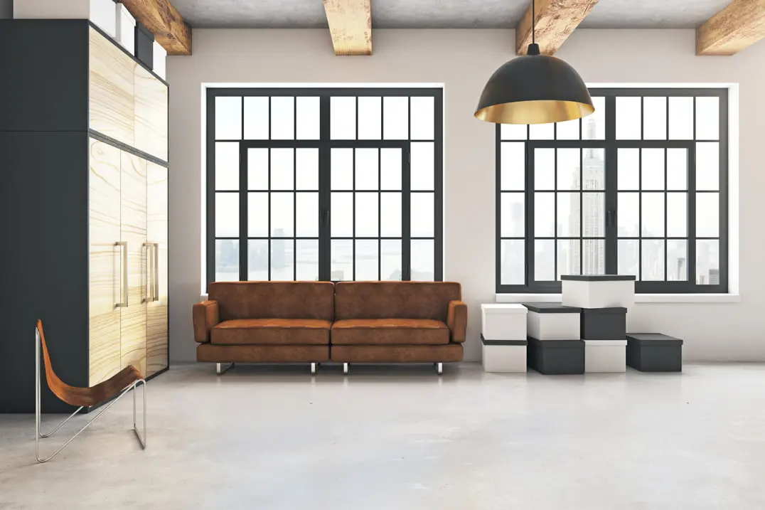 Microcement floor in a loft-type living room with neutral and warm tones that enhance the entrance of light