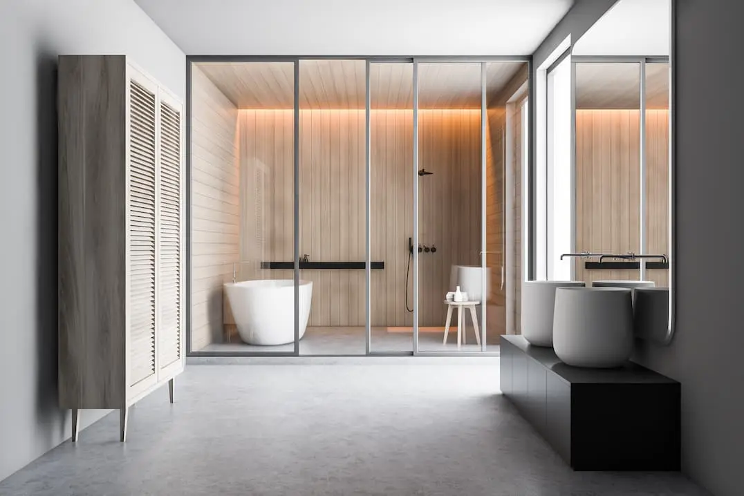 Modern bathroom with shower area with included bathtub and installation of gray microcement on radiant floor