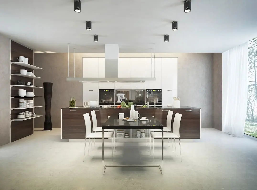 Bright kitchen with an island in the middle and application of gray microcement radiant floor