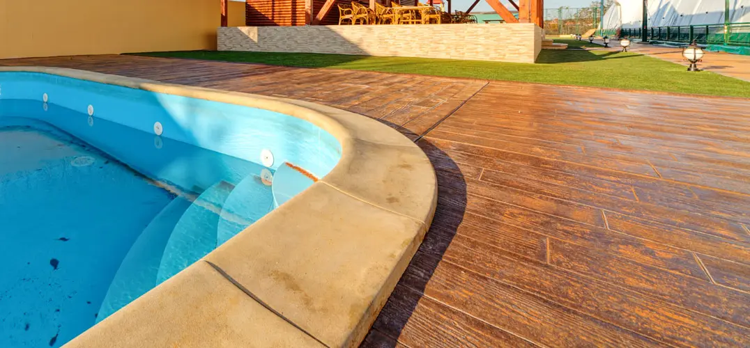 Swimming pool with stamped concrete around