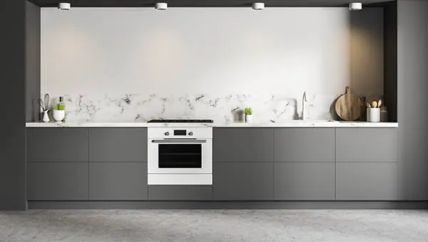 Microcement kitchen in grey tones to which the two-component epoxy system has been applied to block moisture