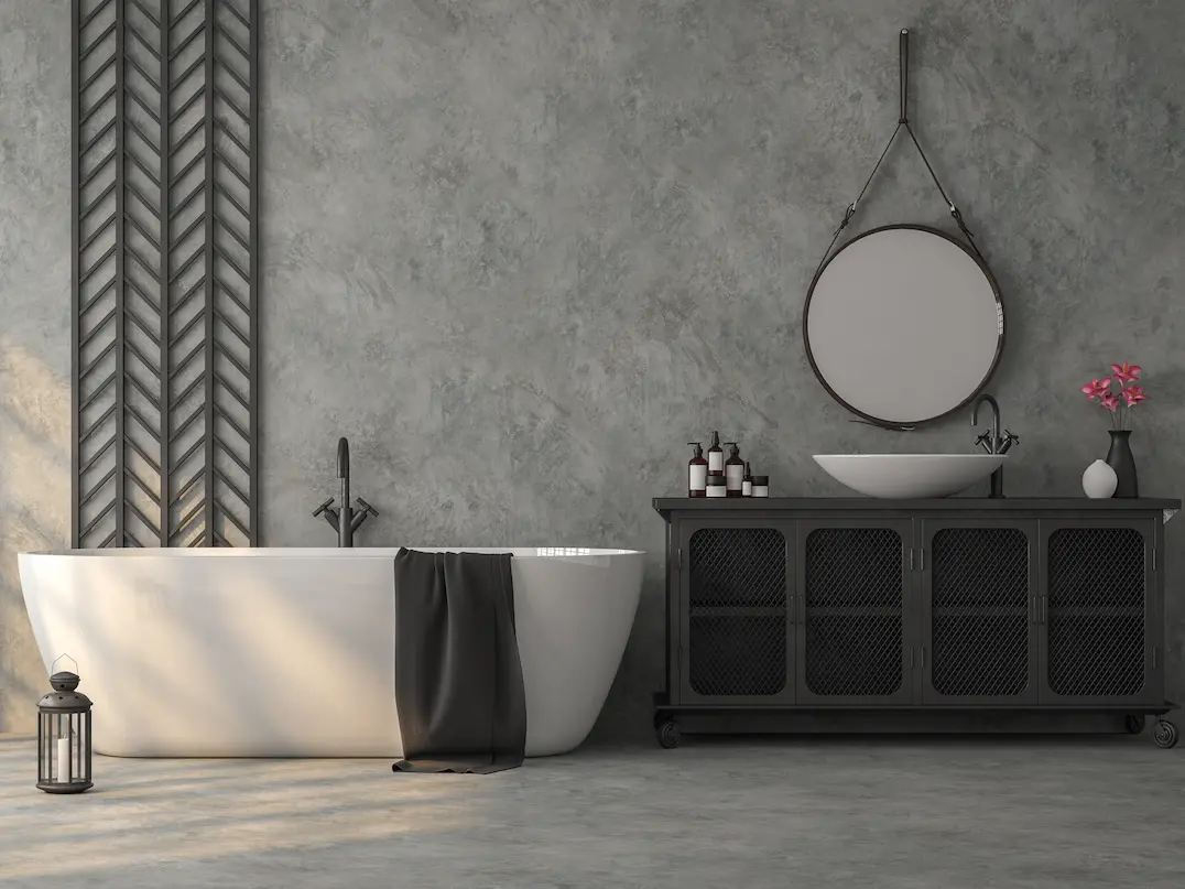 Cuarto de baño en tonalidades grises con pared y suelo de microcemento en Pamplona