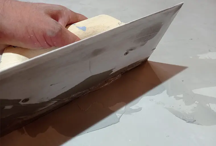 Gummispatel for å fordele mikrosement på gulvet