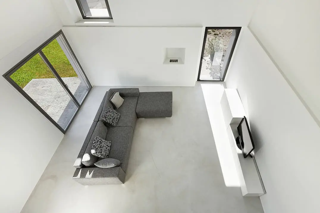 Microcemento trong một phòng khách theo phong cách tối giản với các tông màu trắng và xám